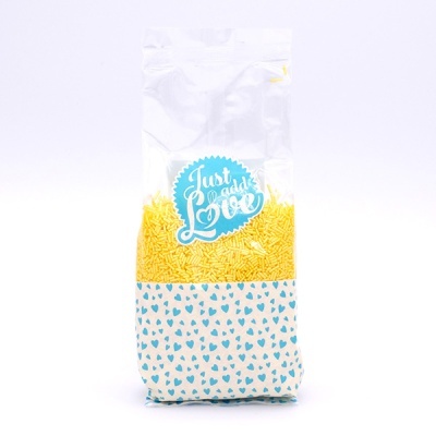 Pacote plástico transparente com confeites amarelos e decoração azul com corações e texto