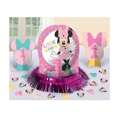 Decoração de festa da Minnie cor-de-rosa com texto LOOK WHO'S 1 e confetis.