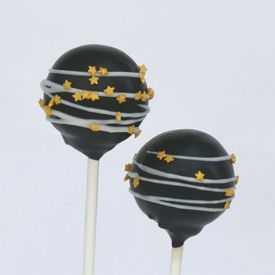 Dois cake pops decorados com chocolate preto, branco e confetis amarelos em forma de estrelas