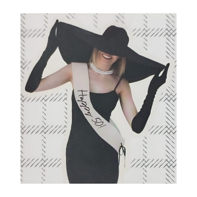 Mulher com vestido e acessórios pretos, faixa 'Happy 50!' e fundo quadriculado cinza