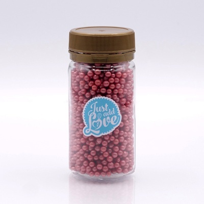 Frasco transparente com tampa castanha e pérolas cor de rosa