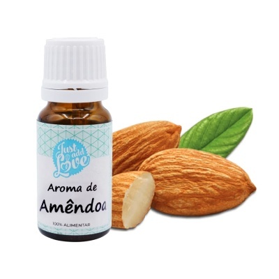 Frasco de aroma de amêndoa em vidro âmbar com tampa branca, junto a amêndoas e folha verde