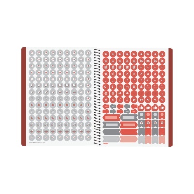 Livro aberto com autocolantes circulares e variados em cinza e vermelho