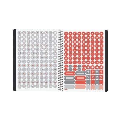 Caderno com páginas abertas mostrando autocolantes cinza e vermelhos com vários ícones