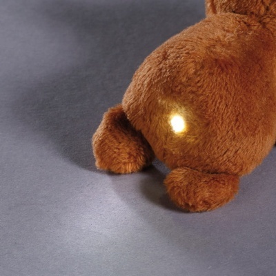 Parte traseira de peluche castanho felpudo com luz branca refletida