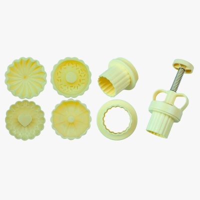 Conjunto de moldes para bolos e biscoitos amarelos com várias formas e pistão.