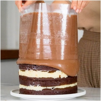 Bolo de chocolate em camadas com cobertura de chocolate sendo feito com molde de acetato.