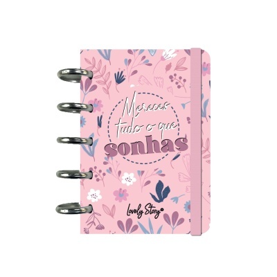 Caderno rosa com flores, argolas metálicas e texto inspirador na capa