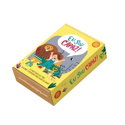 Caixa amarela colorida com ilustrações infantis e texto 'EU SOU CAPAZ!'.