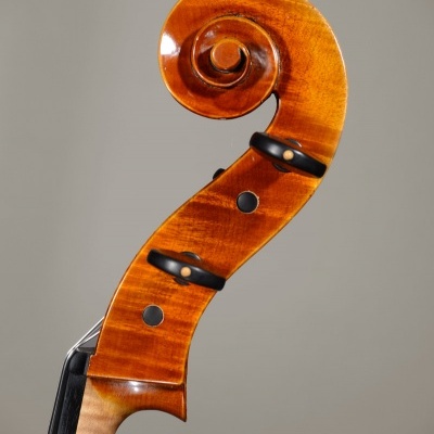 Cabeçote de violino em madeira com acabamento brilhante e fundo cinzento