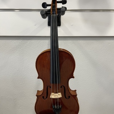 Violino em madeira castanha pendurado numa parede cinza