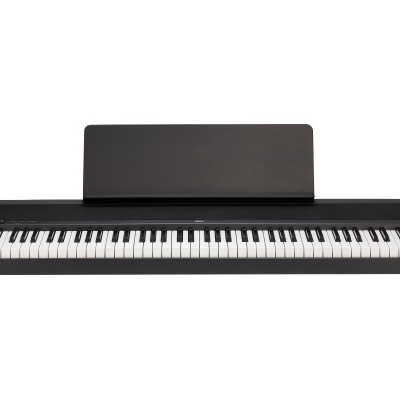 Teclado elétrico preto KORG com suporte para partituras.