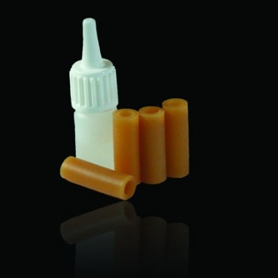 Frasco branco com tampa conta-gotas e quatro cilindros laranja em fundo preto