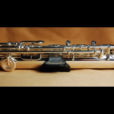 Clarinet prateado com detalhes em preto sobre superfície cor de caramelo