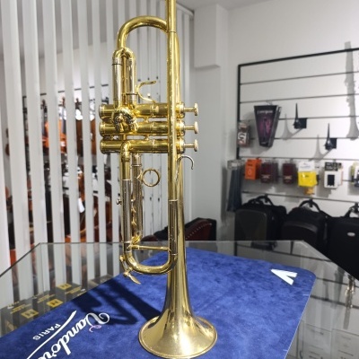 Trompete em latão dourado com três pistões numa loja de música