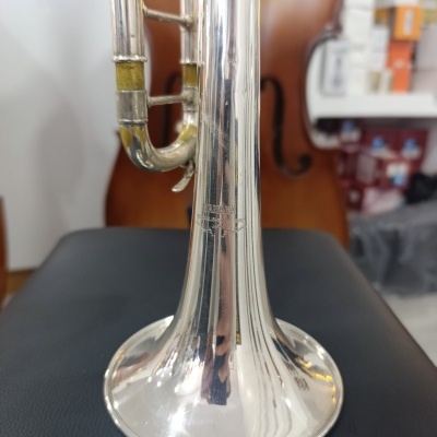 Trompete prateado com gravação YAMAHA colocado numa superfície preta