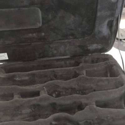 Estojo preto com interior aveludado e compartimentos moldados