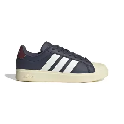 Ténis Adidas azul escuro com riscas brancas e sola creme