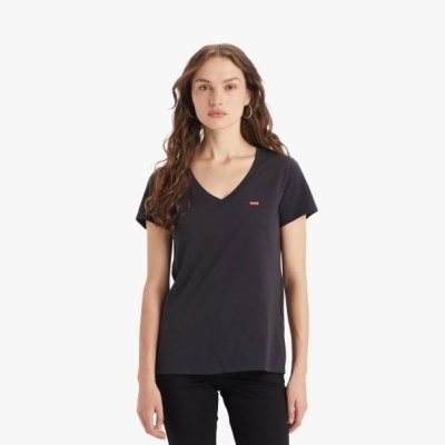 Mulher com t-shirt preta Levis de decote em V e calças pretas em fundo branco
