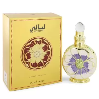 Frasco dourado de perfume com decoração floral e caixa amarela com texto em árabe