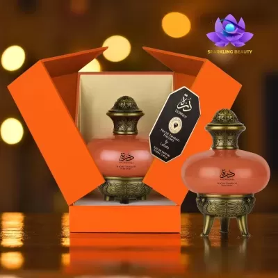 Conjunto perfume laranja com tampa dourada e caixa laranja aberta
