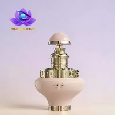 Frasco de perfume rosa claro com detalhes dourados e texto JUJAN PRECIOUS