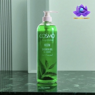 Frasco verde de gel de duche COSMO Neem com tampa branca e rótulo com folhas verdes sobre superfície preta.
