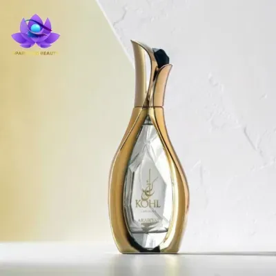 Frasco de perfume dourado e transparente com texto KOHL Luminaire ARABIYATI