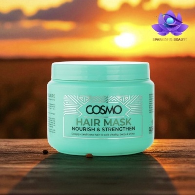 Frasco verde água de máscara para cabelo COSMO numa superfície de madeira ao pôr do sol.