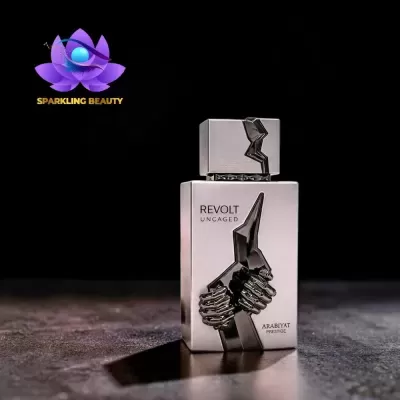 Frasco de perfume prateado com design metálico e texto REVOLT UNCAGED ARABIYAT PRESTIGE