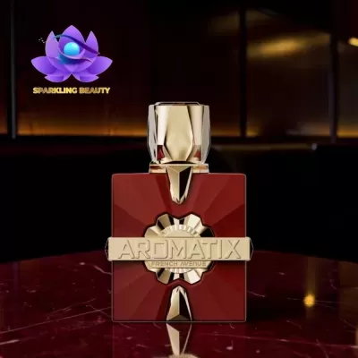 Frasco de perfume vermelho e dourado AROMATIX FRENCH AVENUE sobre mesa de mármore