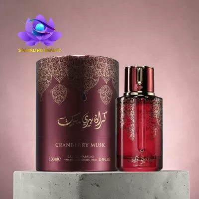 Frasco de perfume vermelho com embalagem cilíndrica bordô e detalhes dourados