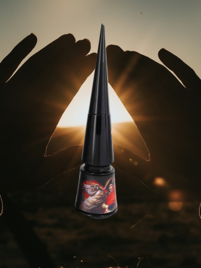 Delineador líquido preto com tampa longa e etiqueta decorativa com imagem colorida, mãos ao fundo ao pôr do sol