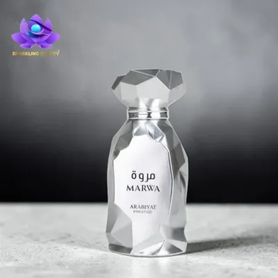 frasco de perfume prateado facetado com texto MARWA ARABIYAT PRESTIGE