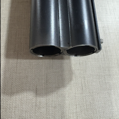  Cano duplo metálico preto de arma sobre tecido bege