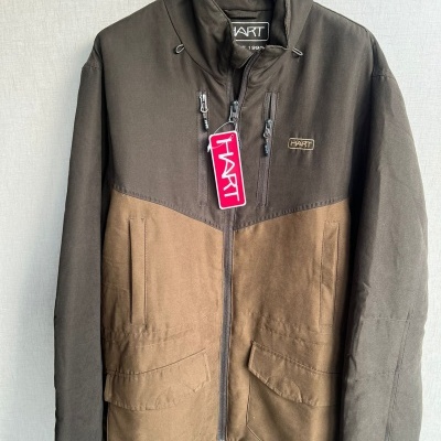 Casaco castanho escuro e claro com fecho e etiquetas HART pendurado num cabide preto