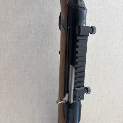 Parte de arma de fogo com madeira castanha e metal preto
