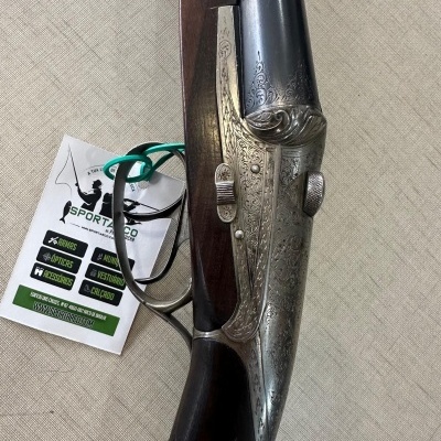 Espingarda de canos duplos com madeira e metal, e etiqueta SPORTZCO
