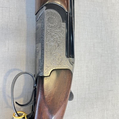 Espingarda de cano duplo com madeira castanha e metal prateado gravado