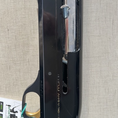 Espingarda semiautomática preta com cabo de madeira e etiqueta