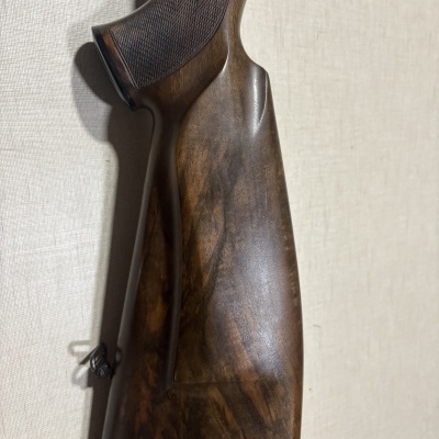 Cabo de arma de madeira com entalhes e parte inferior preta texturizada