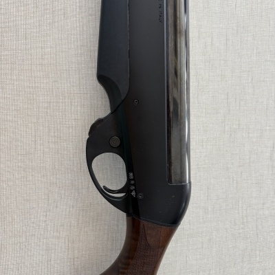 Parte de arma de fogo com cabo de madeira castanha e corpo preto fosco com texto URBINO MADE IN ITALY
