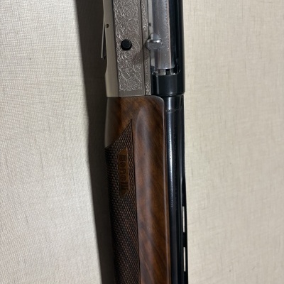 Espingarda Benelli com cano metálico preto e madeira texturizada