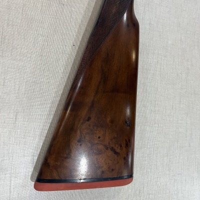 Coronha de madeira castanha escura de rifle com apoio de borracha vermelha