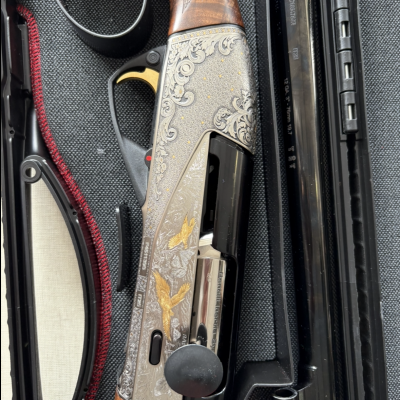 Escopeta gravada com desenhos florais e aves douradas com empunhadura em madeira dentro de estojo preto acolchoado