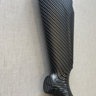 Prótese de perna em fibra de carbono preta com padrão quadriculado