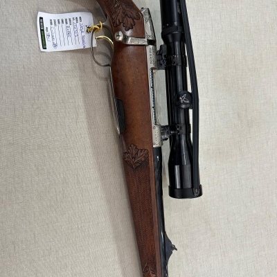 Rifle de madeira com luneta preta e etiqueta pendurada