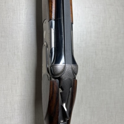 Espingarda de canos paralelos com coronha de madeira e metal prateado