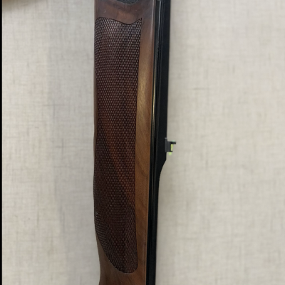 Coronha de madeira escura com textura e detalhes decorativos em metal