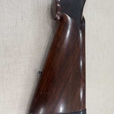 Coronha de madeira escura de arma de fogo com detalhes em preto